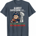Blue t-shirt with a cartoon character and text about Super Bowl LX on a white background