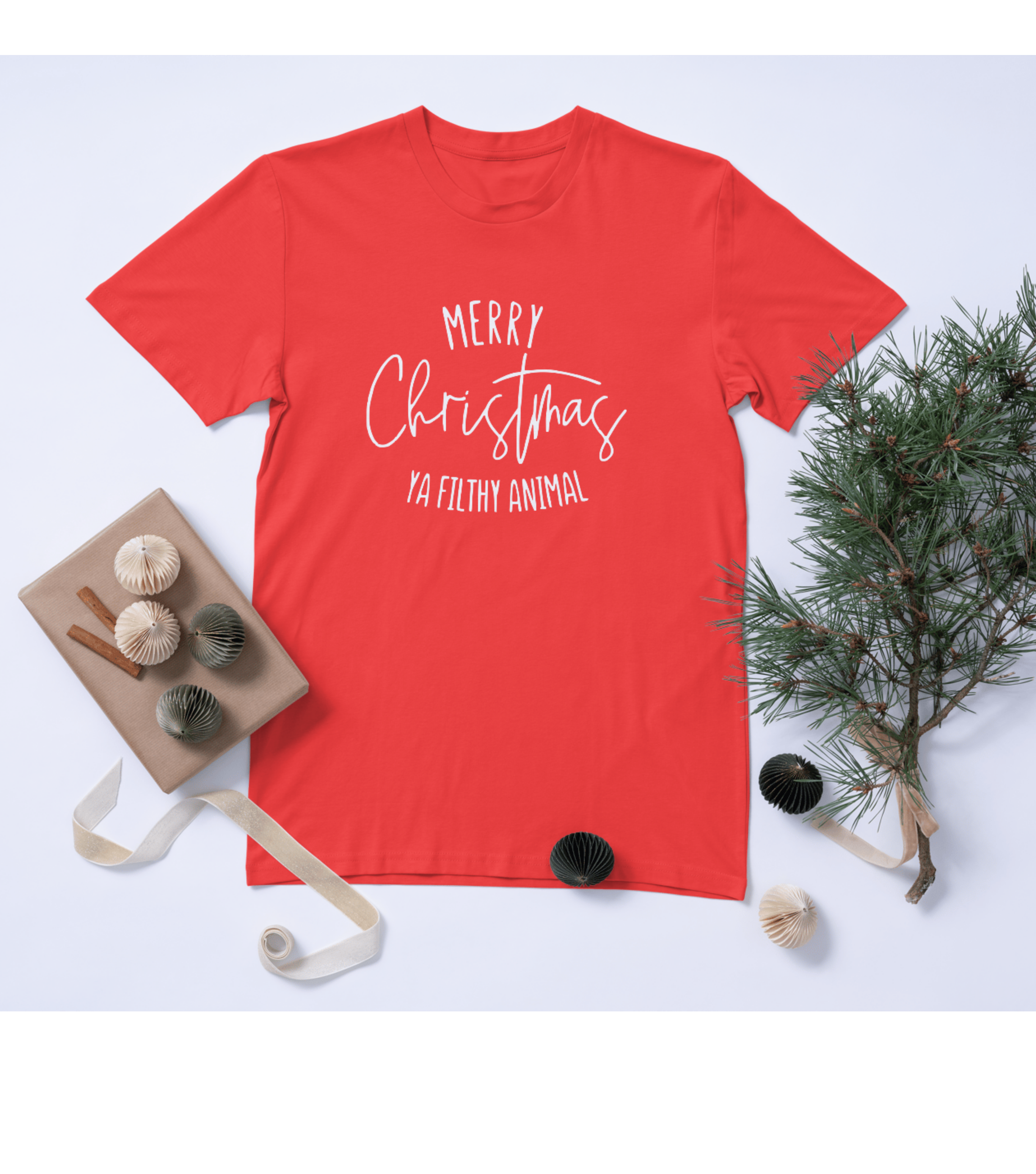 Red t-shirt with 'Merry Christmas Ya Filthy Animal' text, surrounded by Christmas decorations on a light blue background.